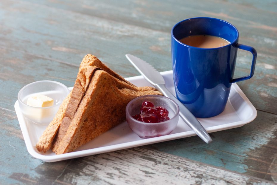 Toast on platter and tea in beaker