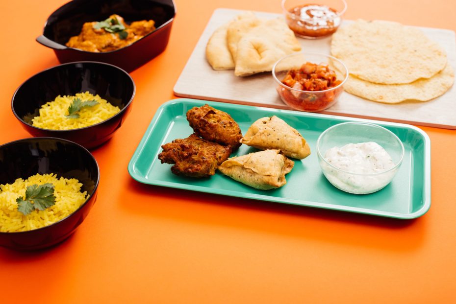 Indian food served on food platters and individual rice bowls