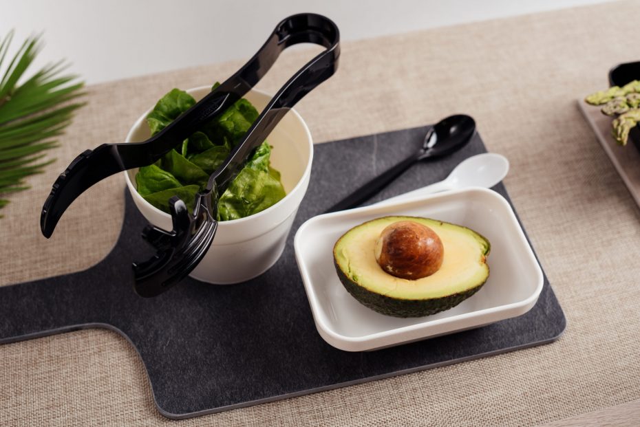 Avocado in a small white rectangular bowl on slate chopping board