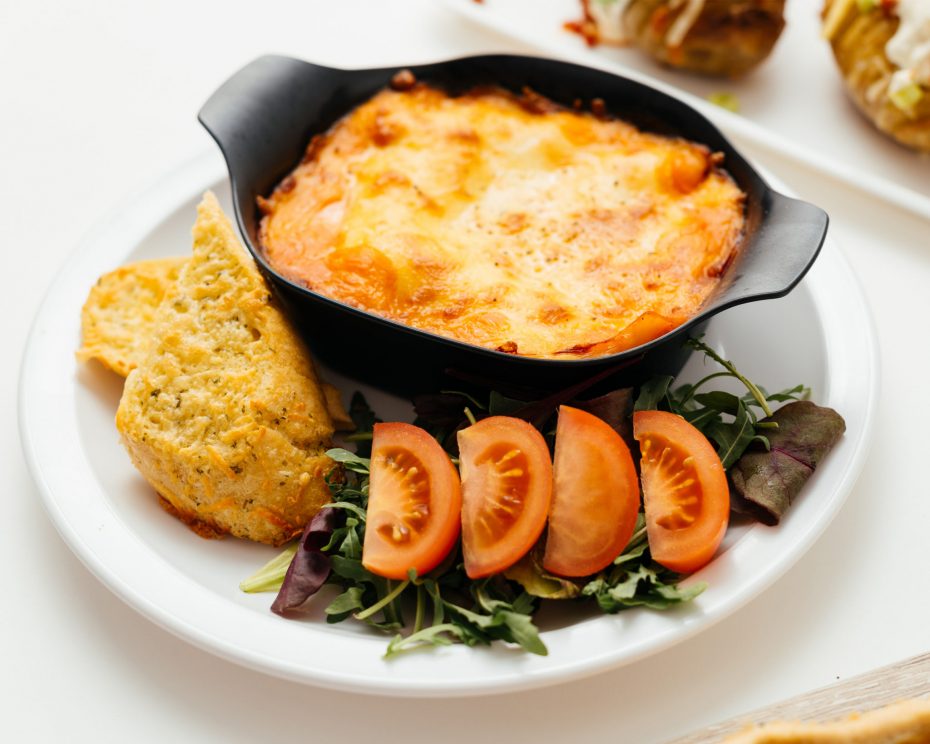 Lasagne in a black individual portion dish