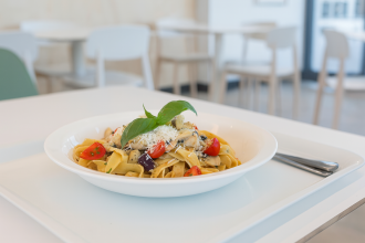 Pasta Dish in Deep Dessert Plate in Canteen Setting