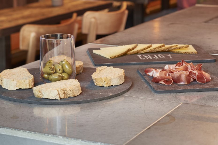 Tapas served on slate planks and Aqua tumbler