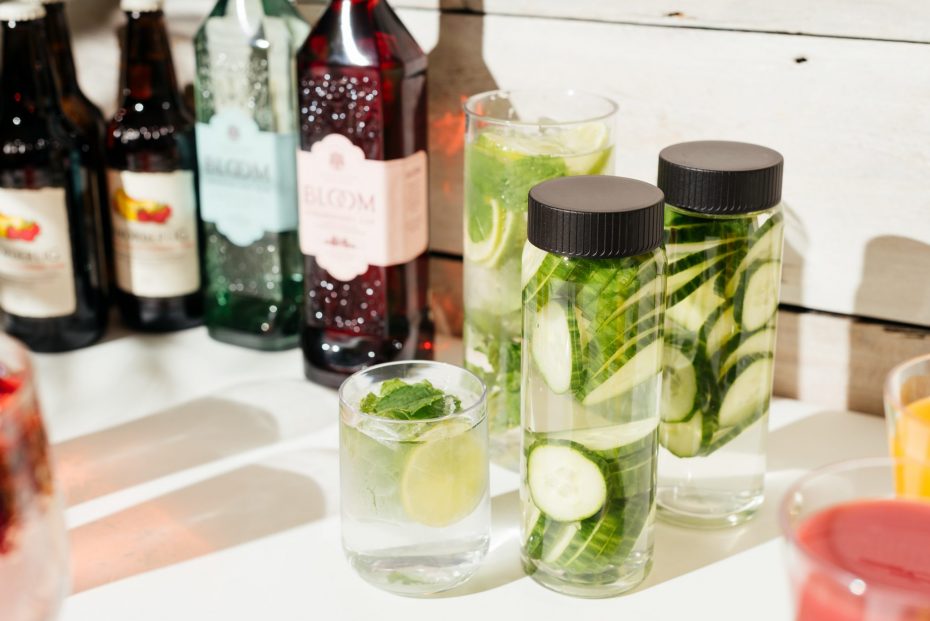 Caraffe and water bottles with cucumber infused water