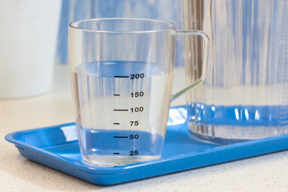 Clear Graduated Beaker with Water on a Blue Tray