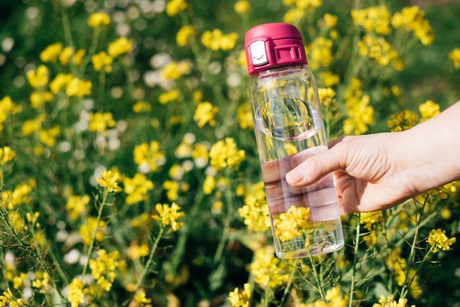 Water Bottle with Pink Sports Cap in a Field