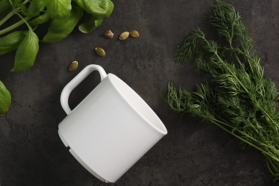 White Mug and Herbs on a Black Background