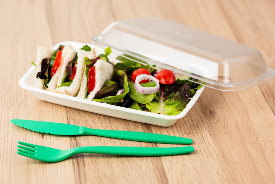 Salad and sandwiches in rectangular bowl