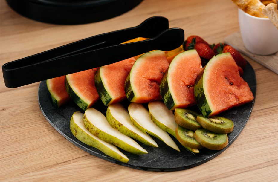 Serving Tongs with Fruit at a Buffet