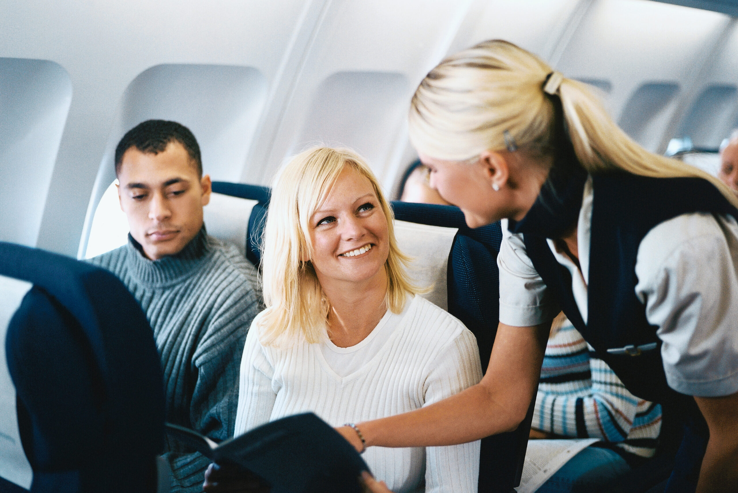 Cabin Crew Assisting Passengers
